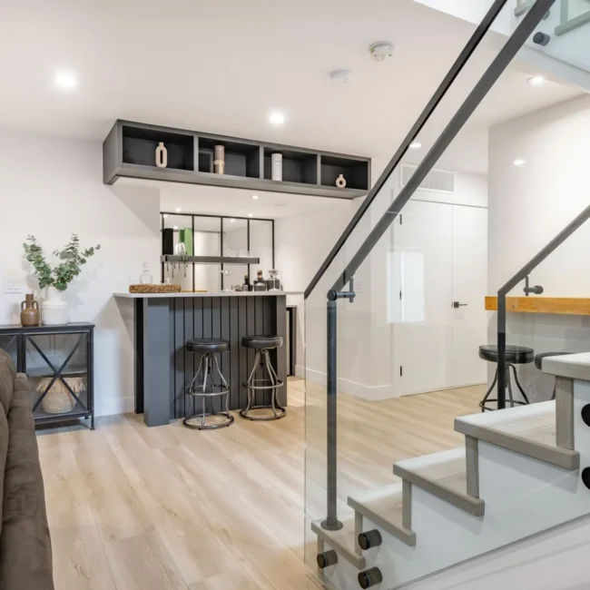 stock-photo-recreation-party-room-with-bar-stairs-with-glass-rails-downstairs-basement-interior-room-with-movie-2275997549-1920w