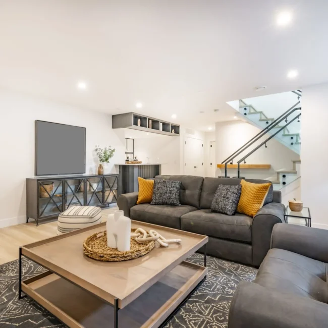 stock-photo-recreation-party-room-with-bar-stairs-with-glass-rails-downstairs-basement-interior-room-with-movie-2275997551-1920w